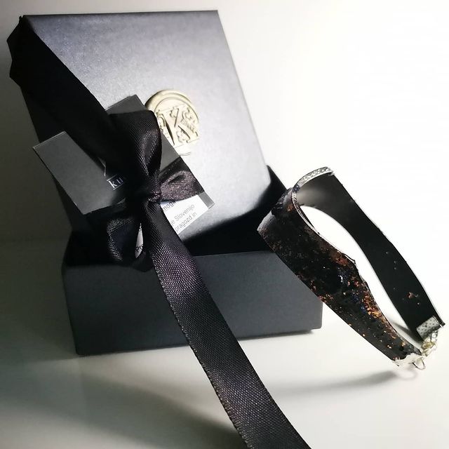 The KUOLMi Silver bracelet is made of 10 million-year-old stone. Due to its black luster and special organic shape, each piece is unique and unrepeatable in its appearance. It is made entirely by hand from coal and stainless steel. The size is adjustable. Jewelry is packaged in a gift box. The story about coal from which the bracelet was made is included as a gift.