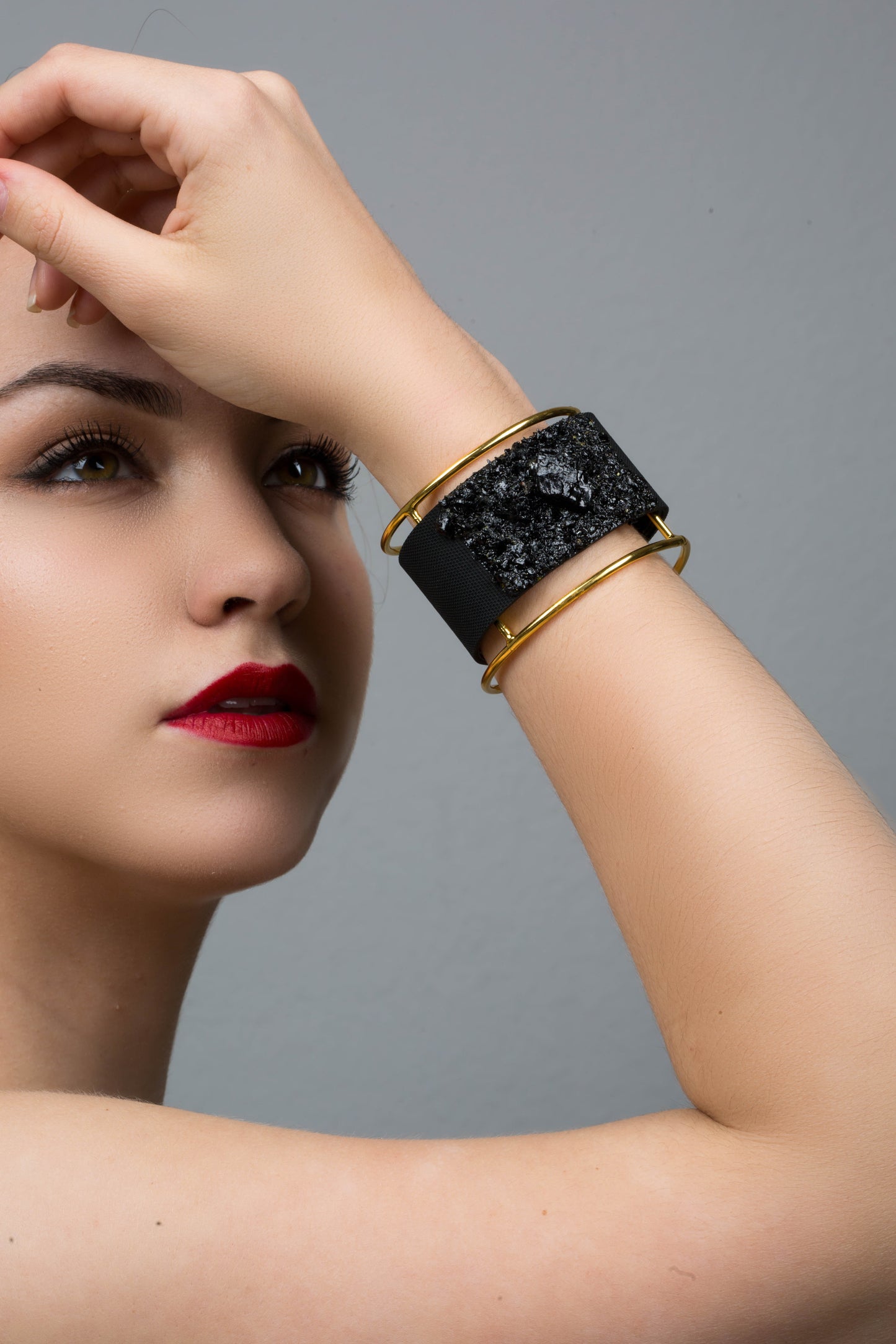 The KUOLMi XL bracelet is made of 10 million-year-old stone. Due to its black luster and special organic shape, each piece is unique and unrepeatable in its appearance. It is made entirely by hand from coal and stainless steel. The size is adjustable. Jewelry is packaged in a gift box. The story about coal from which the bracelet was made is included as a gift.