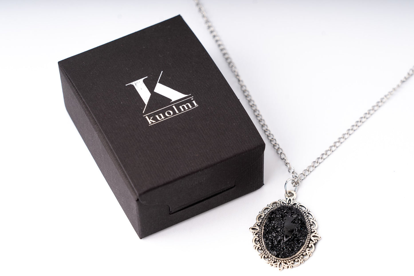 A perfect combination of heart softness, elegant stainless steel chains, and raw organically shaped natural coal… create a statement piece for various occasions.