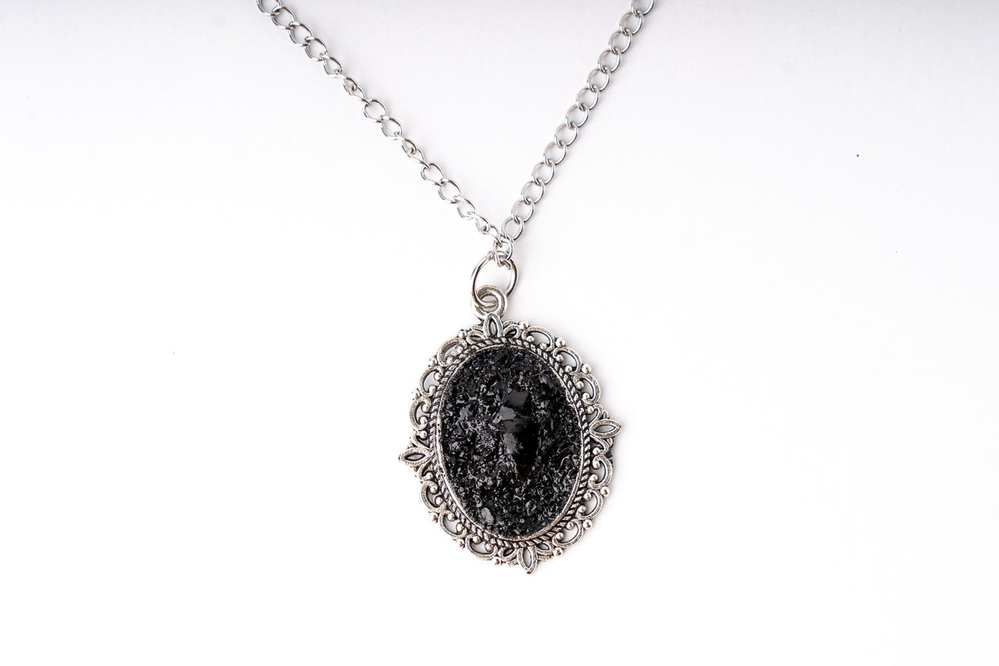 A perfect combination of heart softness, elegant stainless steel chains, and raw organically shaped natural coal… create a statement piece for various occasions.