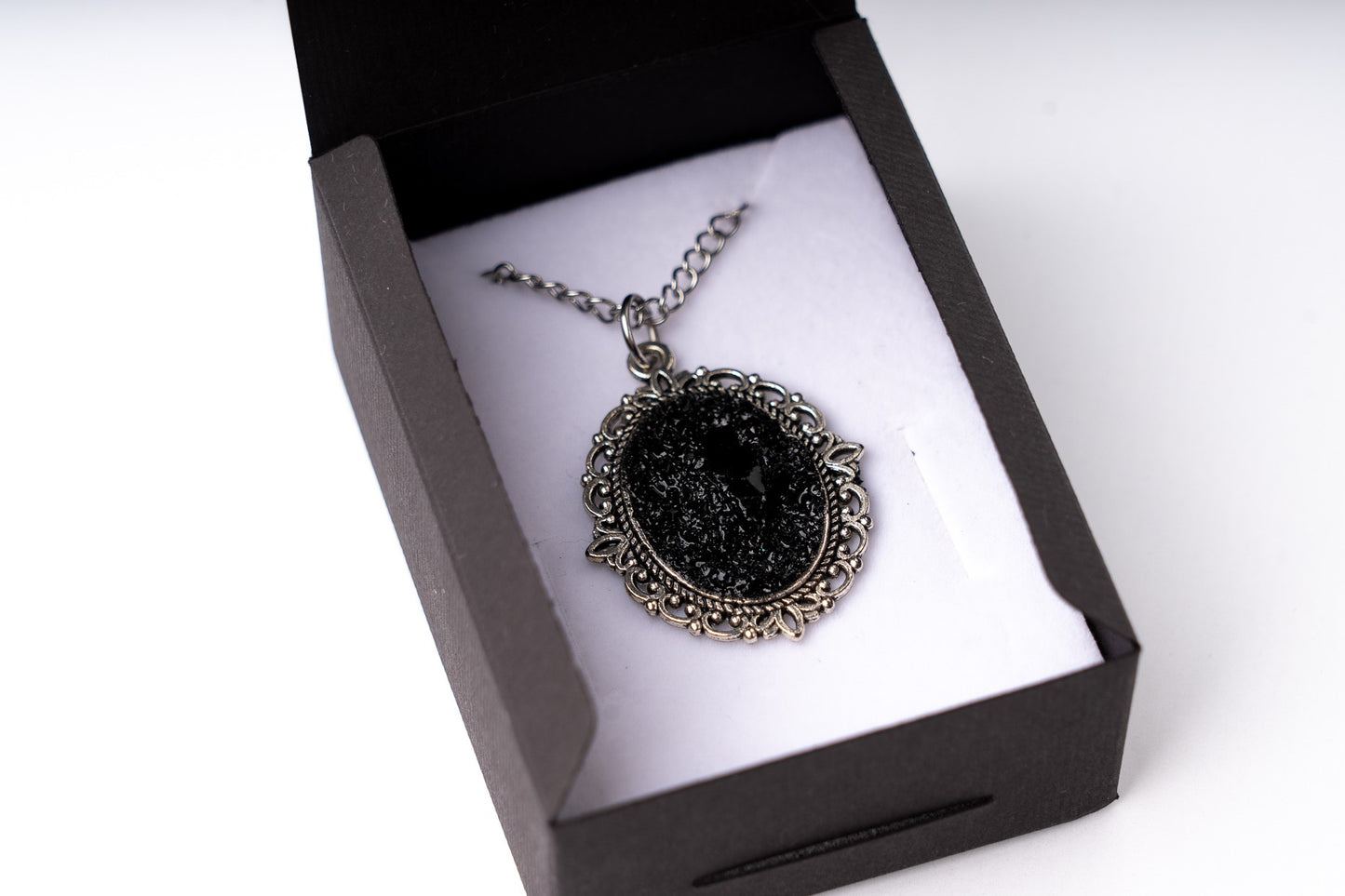 A perfect combination of heart softness, elegant stainless steel chains, and raw organically shaped natural coal… create a statement piece for various occasions.
