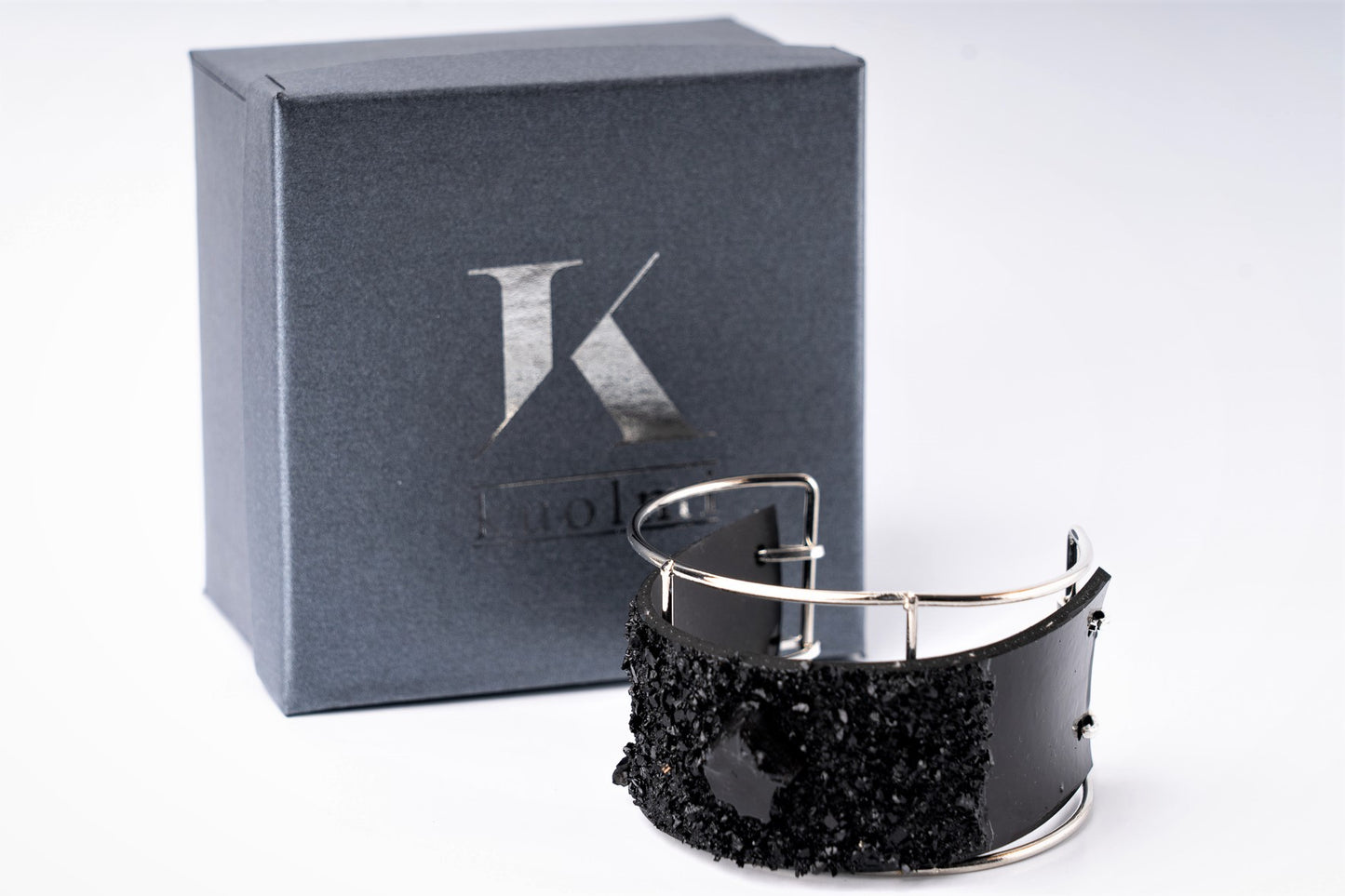 The KUOLMi XL bracelet is made of 10 million-year-old coal. Due to its black luster and special organic shape, you will be noticed at all times. This bracelet will instantly upgrade your styling. A statement piece that combines edgy attitude and high fashion. You can choose a different style every day and upgrade it with this bracelet. You will rock them all- formal dress and high heels or something casual. This bracelet goes great with high heels, flip flops, and everything in between.