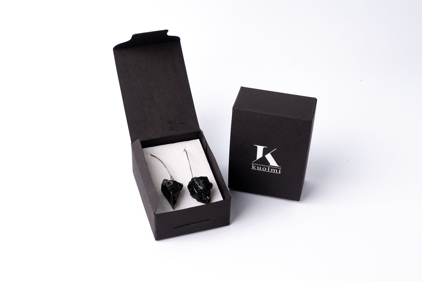 The KUOLMi dangling earrings are a fantastic accessory that makes the perfect look. The 10 million-year-old stone will shine on you with all its brilliance. Earrings are made of coal and stainless steel. The image is symbolic because each piece is handmade, unrepeatable, and unique. The earrings are packaged in gift packaging with an added description of the coal story. Handmade in Slovenia.