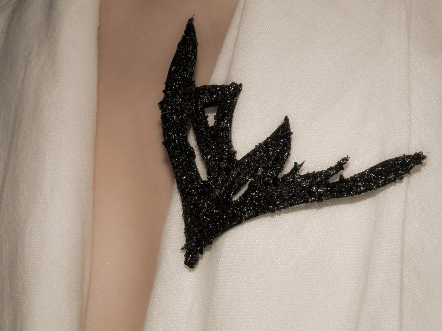 The KUOLMi handmade brooch is a fantastic accessory that makes the look perfect. The 10 million-year-old stone will shine on you with all its brilliance. The brooch is made of coal and stainless steel. The image is symbolic because each piece is handmade, unrepeatable, and unique. It is really light to wear. The brooch is packaged in gift packaging with an added description of the coal story.