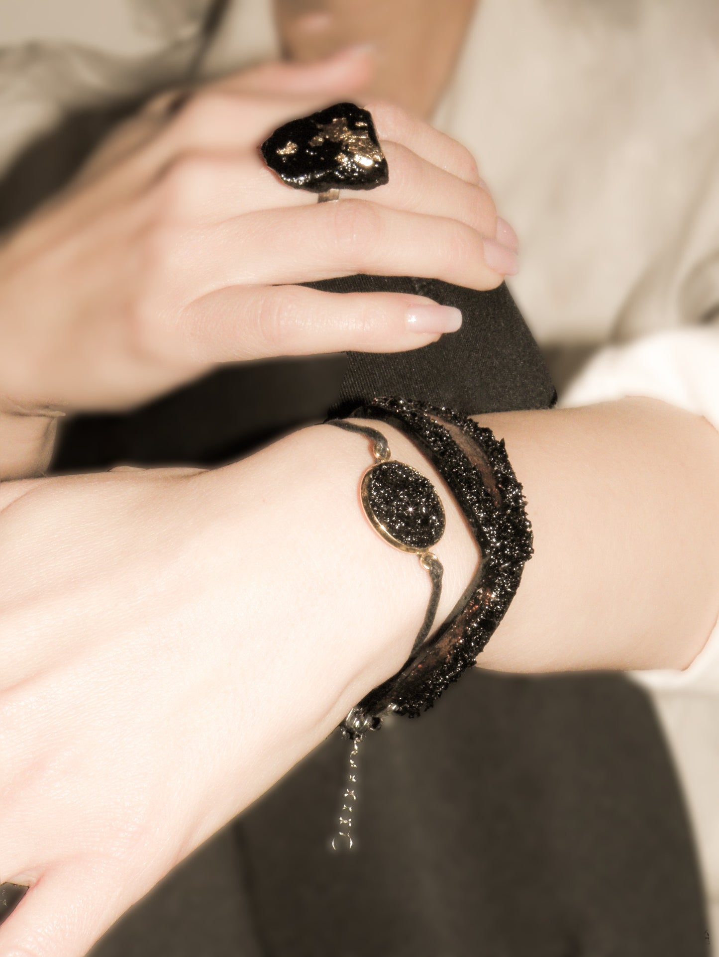 The KUOLMi Silver bracelet is made of 10 million-year-old stone. Due to its black luster and special organic shape, each piece is unique and unrepeatable in its appearance. It is made entirely by hand from coal and stainless steel. The size is adjustable. Jewelry is packaged in a gift box. The story about coal from which the bracelet was made is included as a gift.