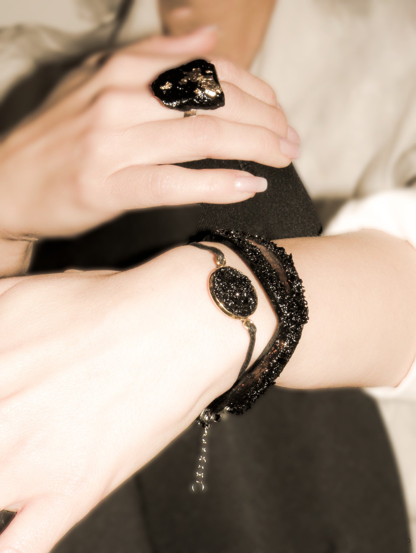 The KUOLMi Rosegold bracelet is made of 10 million-year-old stone. Due to its black luster and special organic shape, each piece is unique and unrepeatable in its appearance. It is made entirely by hand from coal and stainless steel. The size is adjustable. Jewelry is packaged in a gift box. The story about coal from which the bracelet was made is included as a gift.