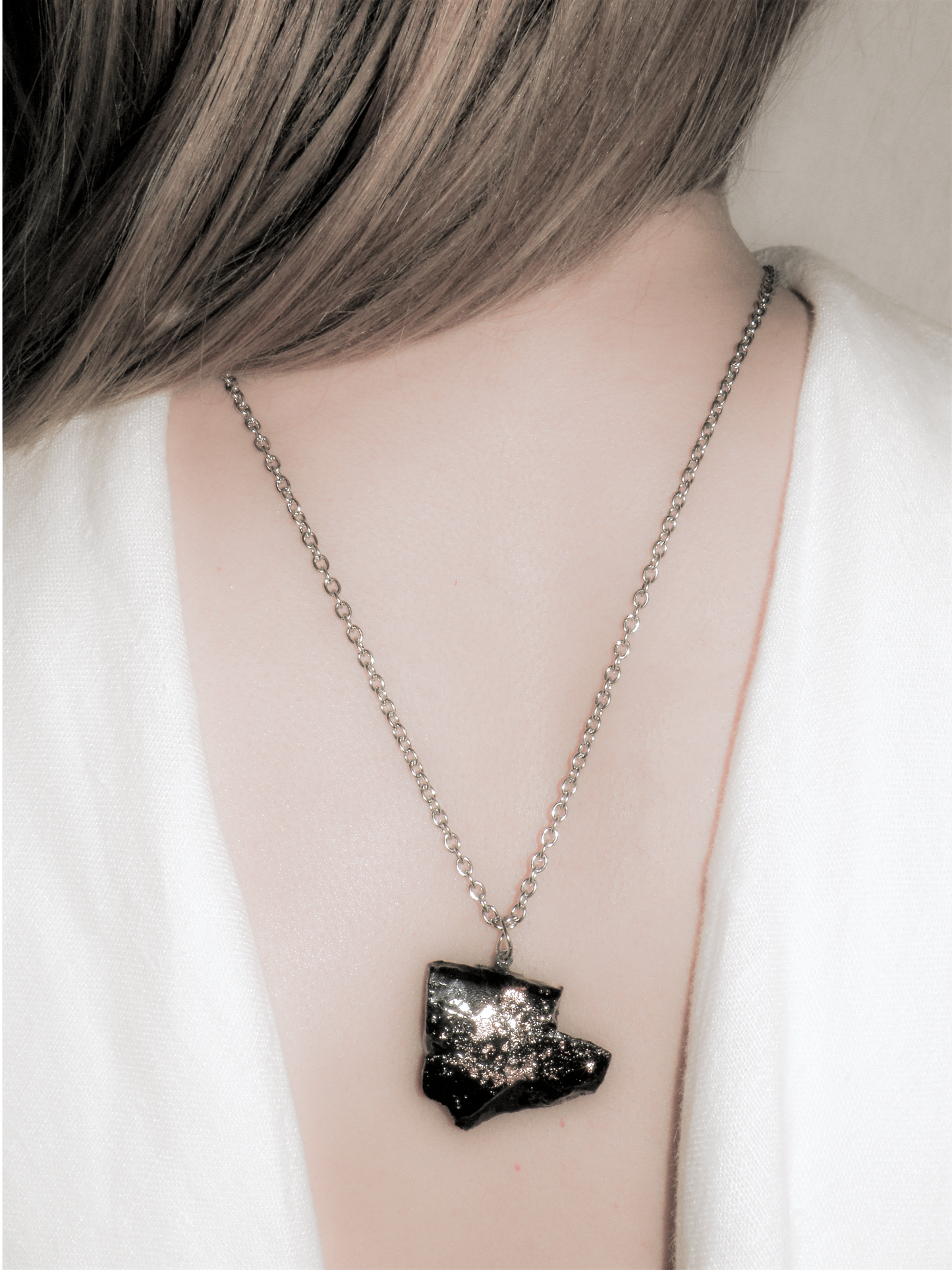 The KUOLMi Necklace is made of 10 million-year-old stone. Due to its black luster and special organic shape, each piece is unique and unrepeatable in its appearance. It is made entirely by hand from coal and stainless steel. The size is adjustable. Jewelry is packaged in a gift box. The story about coal from which the bracelet was made is included as a gift. Mighty and powerful.