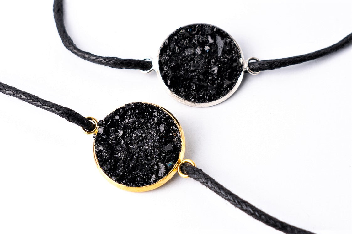 Made of coal and stainless steel. This string charm bracelet is a perfect gift for yourself or your family and friends. It adds the perfect touch to any outfit and is both waterproof and durable (should still be handled with care). You can choose between the gold and silver versions.