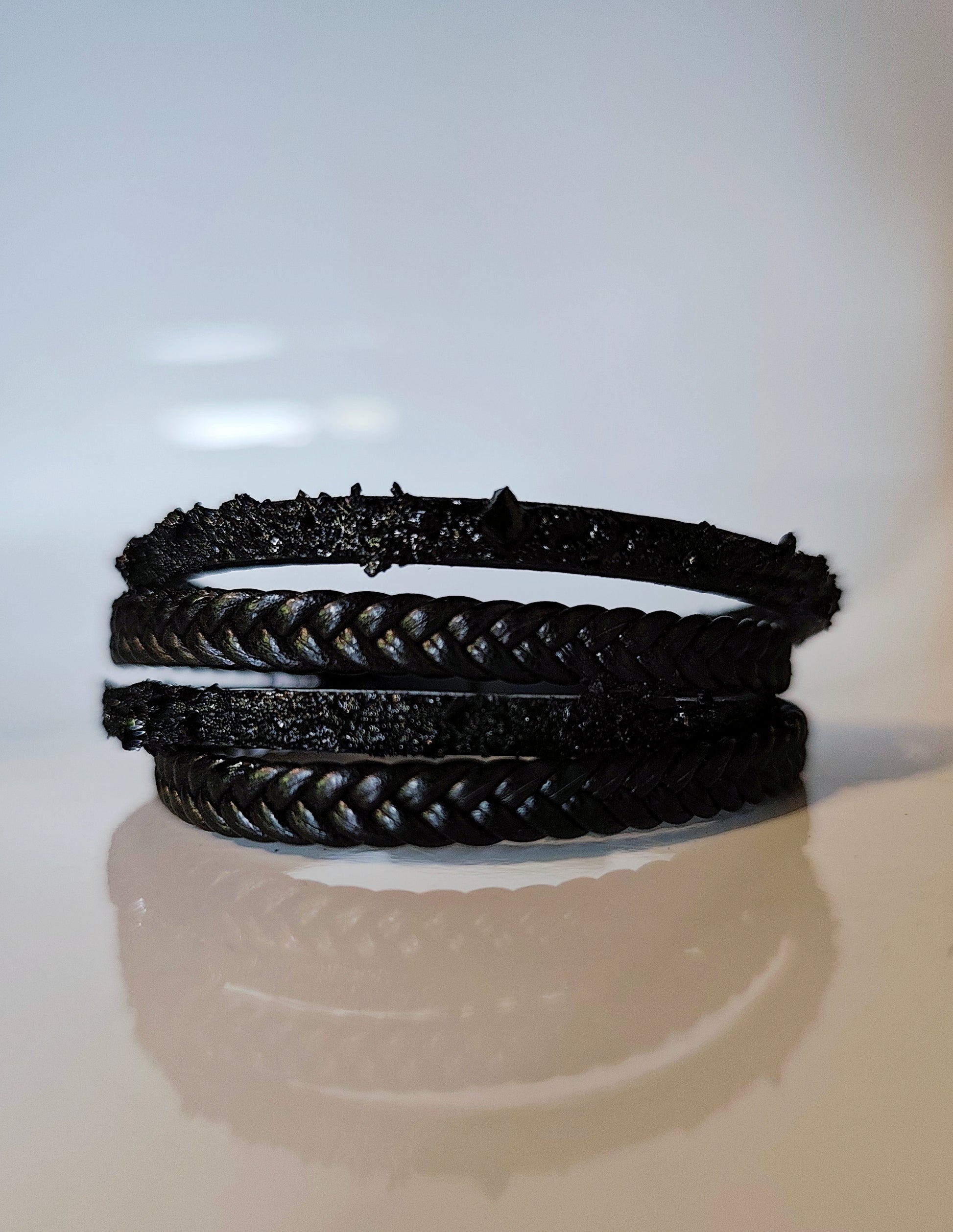 Leather Bracelet with Coal Accent
A refined blend of heritage and modern design. Handcrafted from premium leather, this bracelet features a unique weave of four straps and a symbolic element – natural Slovenian coal.

Available in two finishes:
🖤 Matte coal – for understated elegance
✨ High-gloss coal – for a bold, refined contrast

Details:
– Length: 18 cm
– Width: 2 cm
– Unisex: suitable for women and men
– Comes in a premium gift box
– Includes a story card about the coal's meaning and origin
