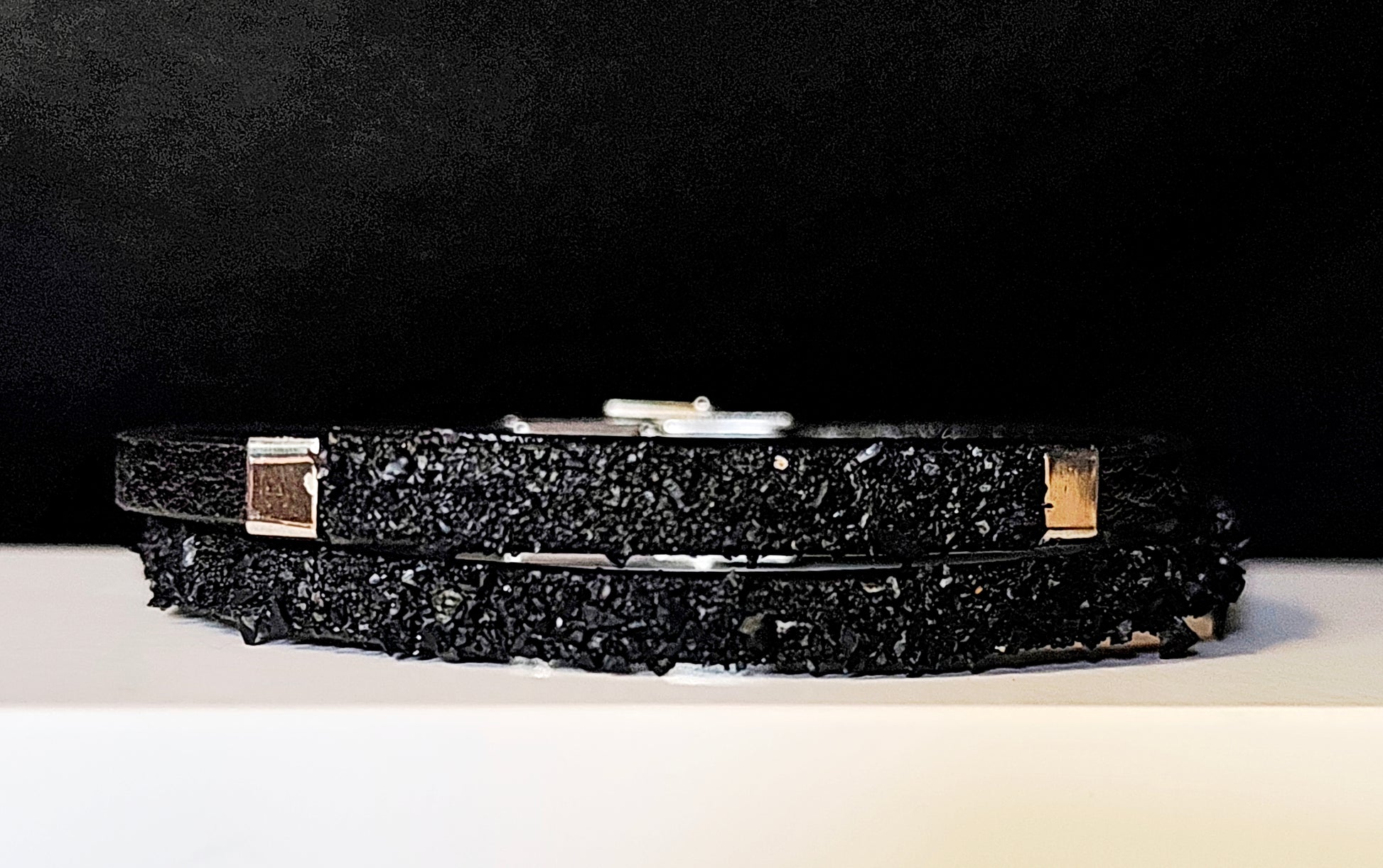 Leather Bracelet with Coal Accent
A refined blend of heritage and modern design. Handcrafted from premium leather, this bracelet features a unique weave of four straps and a symbolic element – natural Slovenian coal.

Available in two finishes:
🖤 Matte coal – for understated elegance
✨ High-gloss coal – for a bold, refined contrast

Details:
– Length: 22 cm
– Width: 2 cm
– Unisex: suitable for women and men
– Comes in a premium gift box
– Includes a story card about the coal's meaning and origin
