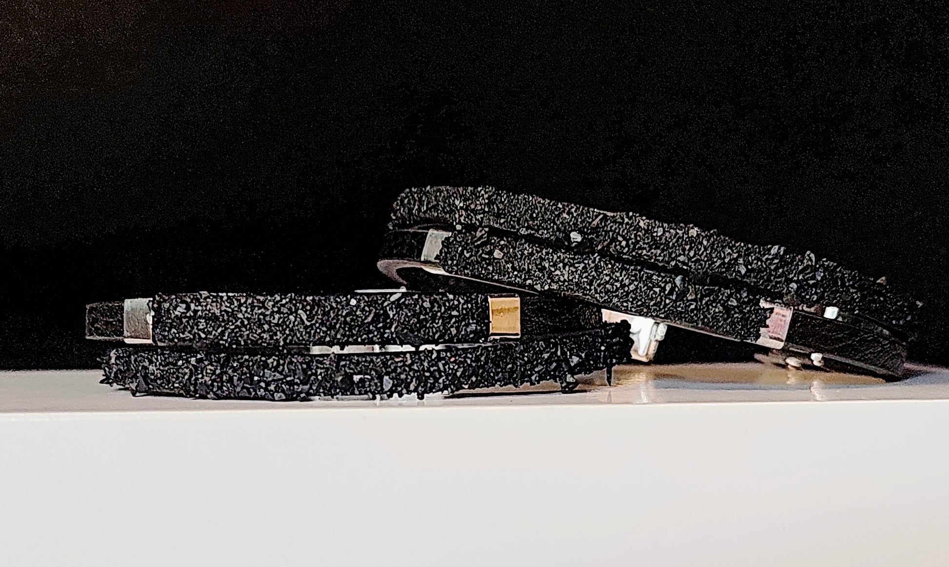 Leather Bracelet with Coal Accent
A refined blend of heritage and modern design. Handcrafted from premium leather, this bracelet features a unique weave of four straps and a symbolic element – natural Slovenian coal.

Available in two finishes:
🖤 Matte coal – for understated elegance
✨ High-gloss coal – for a bold, refined contrast

Details:
– Length: 22  cm
– Width: 2 cm
– Unisex: suitable for women and men
– Comes in a premium gift box
– Includes a story card about the coal's meaning and origin
