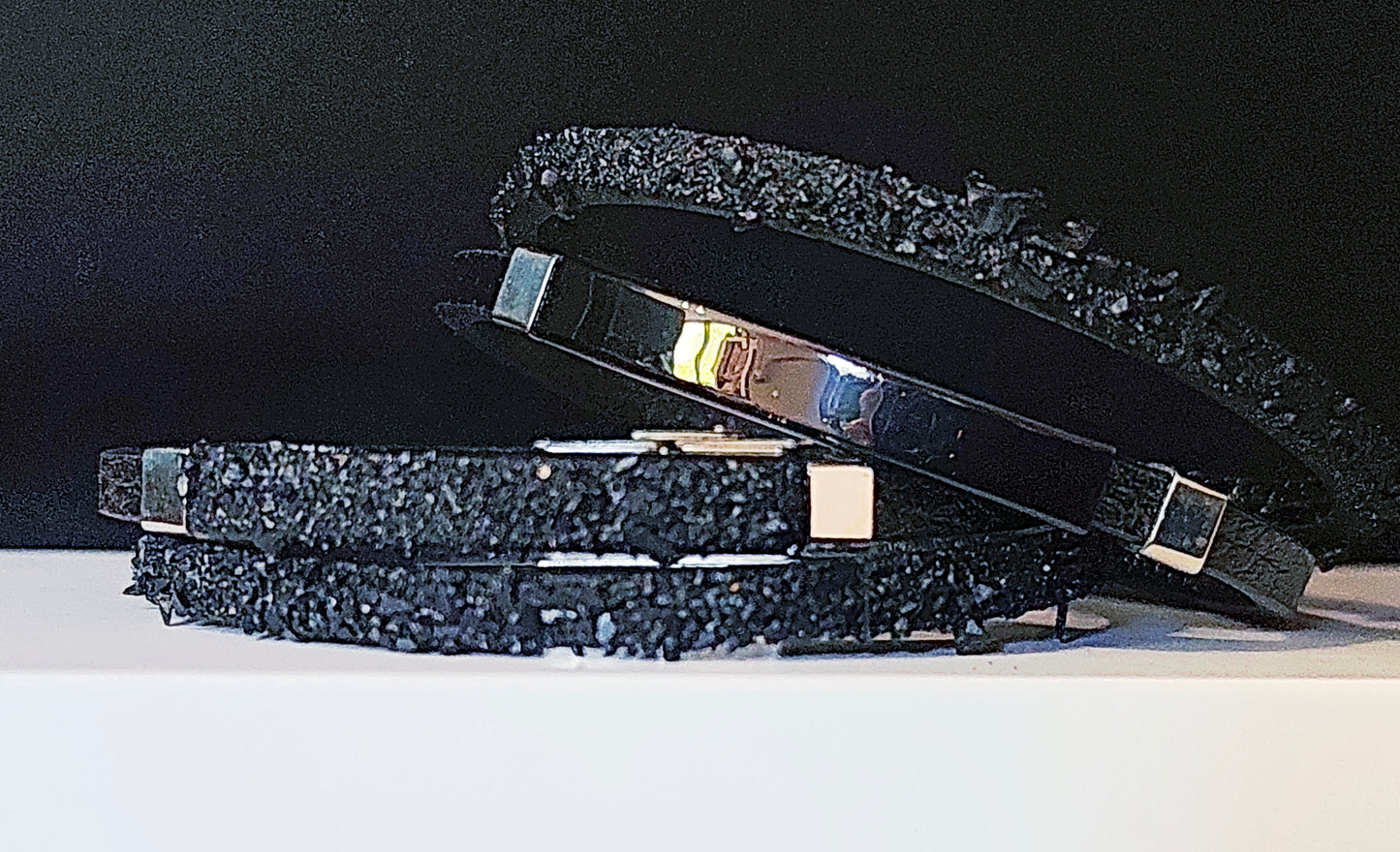 Leather Bracelet with Coal Accent
A refined blend of heritage and modern design. Handcrafted from premium leather, this bracelet features a unique weave of four straps and a symbolic element – natural Slovenian coal.

Available in two finishes:
🖤 Matte coal – for understated elegance
✨ High-gloss coal – for a bold, refined contrast

Details:
– Length: 22 cm
– Width: 2 cm
– Unisex: suitable for women and men
– Comes in a premium gift box
– Includes a story card about the coal's meaning and origin
