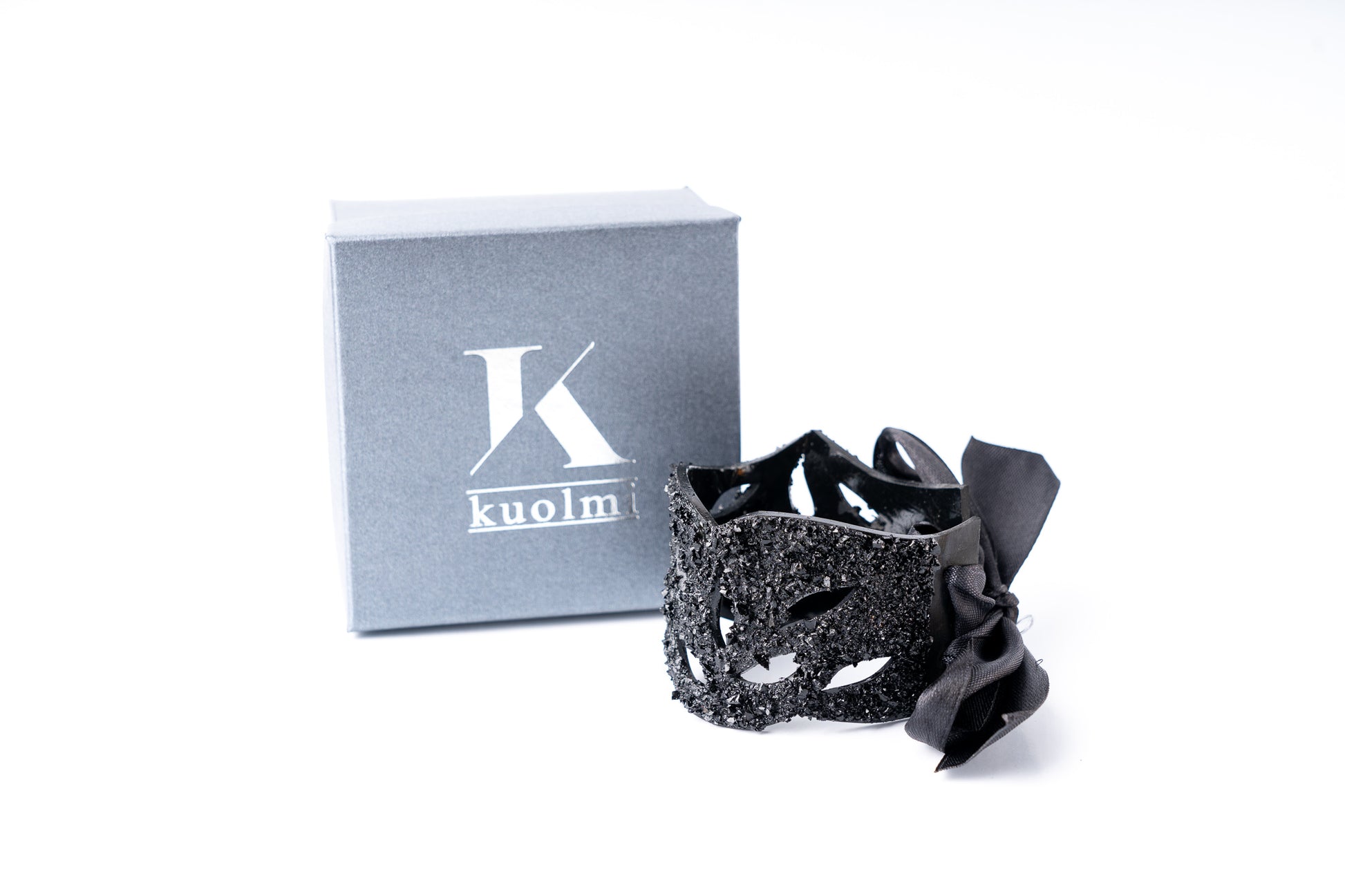 The KUOLMi Lace bracelet is made of 10 million-year-old stone. Due to its black luster and special organic shape, each piece is unique and unrepeatable in its appearance. It is made entirely by hand from coal and stainless steel. The size is adjustable. Jewelry is packaged in a gift box. The story about coal from which the bracelet was made is included as a gift.  Mighty and powerful.