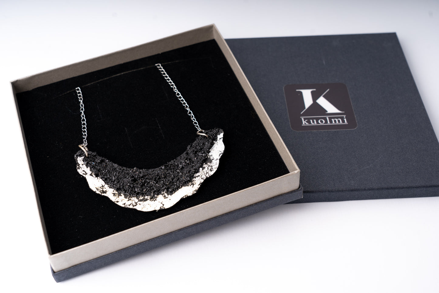The KUOLMi Necklace is made of 10 million-year-old stone. Due to its black luster and special organic shape, each piece is unique and unrepeatable in its appearance. It is made entirely by hand from coal and stainless steel. The size is adjustable. Jewelry is packaged in a gift box. The story about coal from which the necklace was made is included as a gift.    Mighty and powerful.