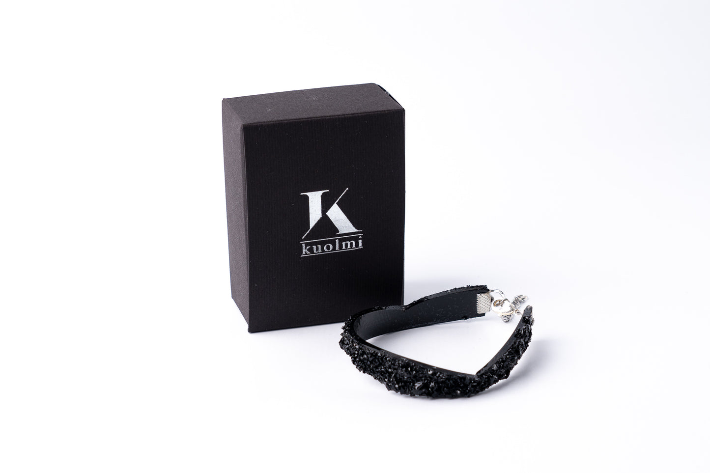 The KUOLMi Black bracelet is made of 10 million-year-old stone.  Due to its black luster and special organic shape, each piece is unique and unrepeatable in its appearance. It is made entirely by hand from coal and stainless steel. The size is adjustable. Jewelry is packaged in a gift box. The story about coal from which the bracelet was made is included as a gift.    Mighty and powerful.