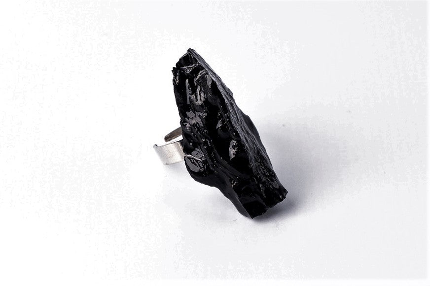The 10 million-year-old stone will shine on your hand with all its brilliance. The ring is made of coal and stainless steel.  This statement piece combines an edgy attitude and fashion. It is comfortable to wear and very durable at the same time. Try to wear it with various stylings, from casual to edgy. This ring brings elegance and a classy feel to any wardrobe.